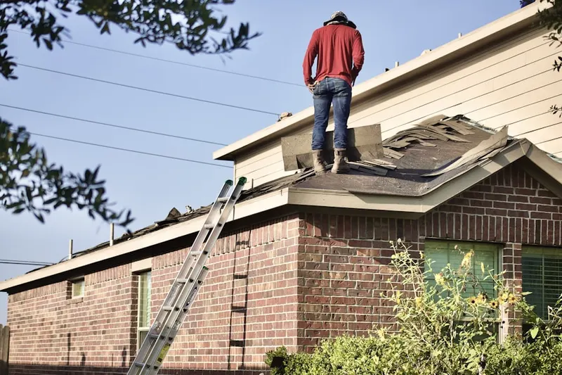 Professional roofer working on a residential roof in Belle Terre Acres